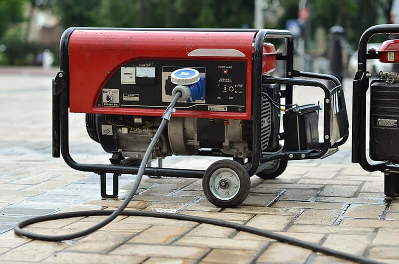 Portable generator on a brick sidewalk