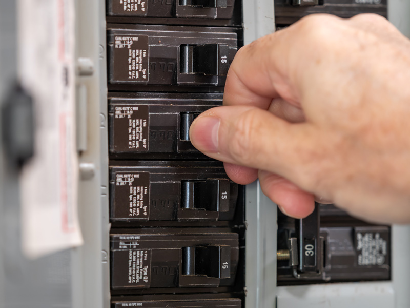 An electrician checking the circuit breakers