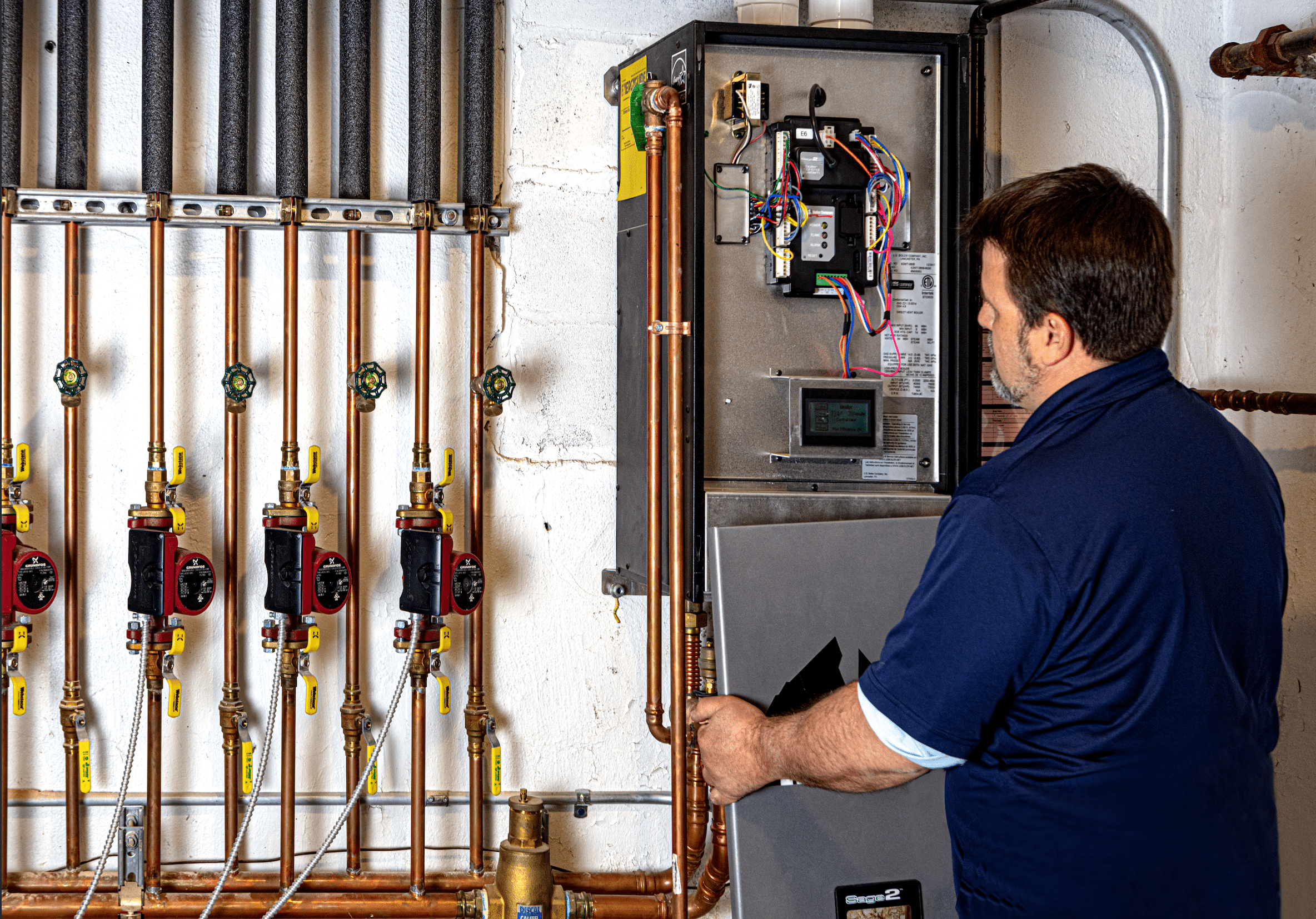 expert hvac technician making repairs to a boiler